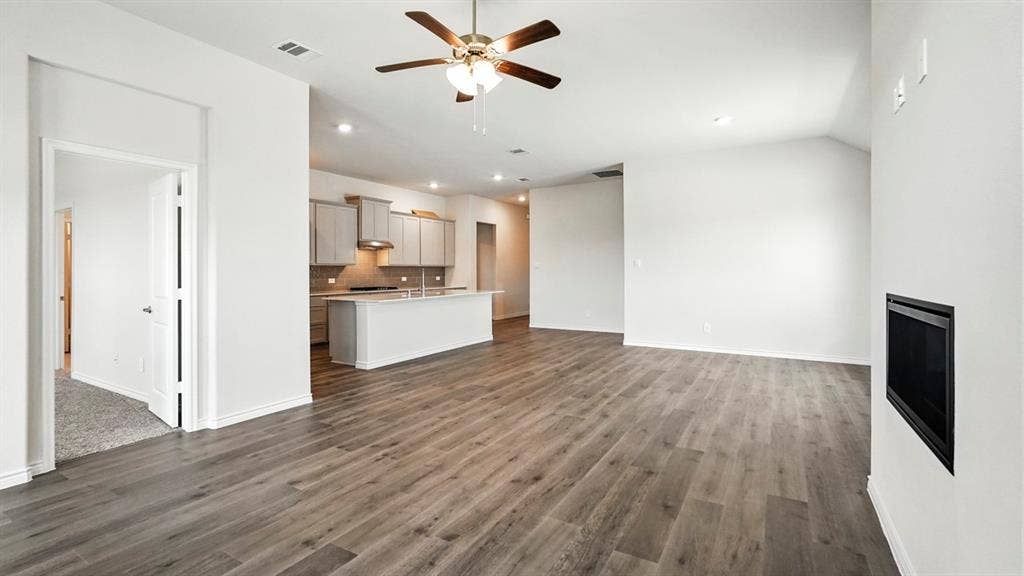 2503 Wesley Avenue, Royse City, TX 75189 Spacious living area featuring wood-finish flooring, a ceiling fan with integrated lighting, and recessed lighting