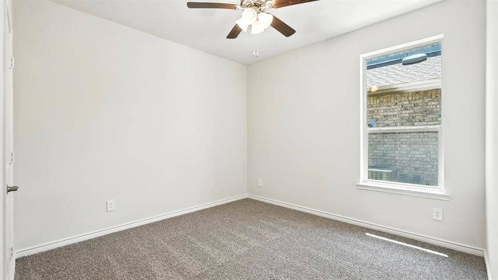 2503 Wesley Avenue, Royse City, TX 75189 Carpeted interior space featuring light-toned walls, a single window, and a ceiling fan with integrated lighting