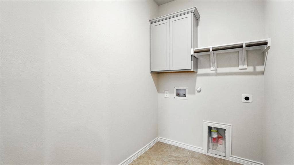 2503 Wesley Avenue, Royse City, TX 75189 Laundry area featuring a built-in upper cabinet, hanging rod, shelving, and utility hookups