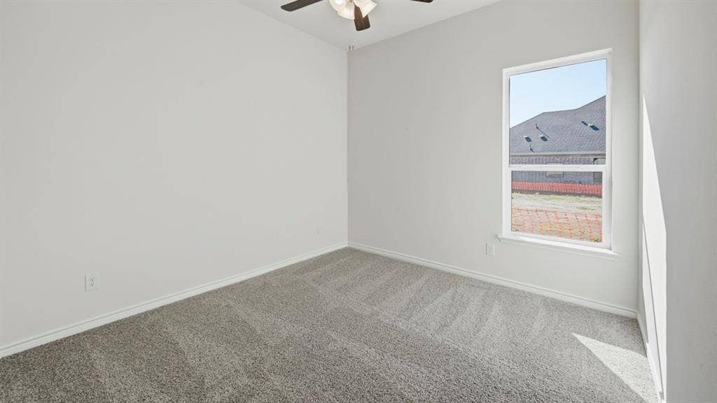 2506 Wesley Avenue, Royse City, TX 75189 Spacious room featuring light gray carpeting, white walls, a single window, and a ceiling fan with integrated lighting
