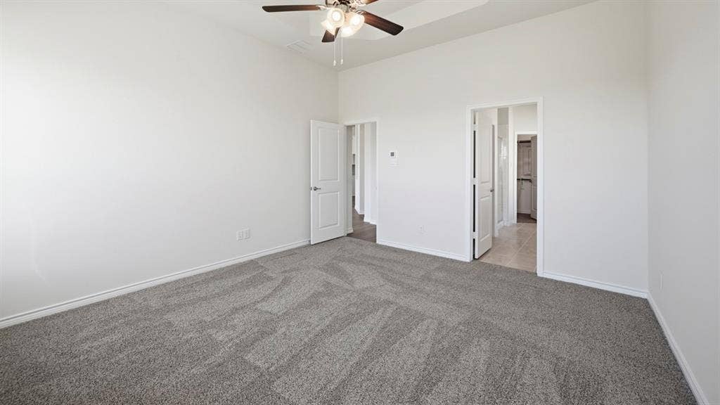2506 Wesley Avenue, Royse City, TX 75189 Spacious room featuring neutral carpeting, white baseboards, and a ceiling fan with integrated lighting