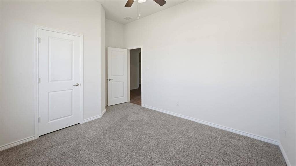 2506 Wesley Avenue, Royse City, TX 75189 Bedroom featuring neutral grey carpeting, white baseboards, and bright white walls