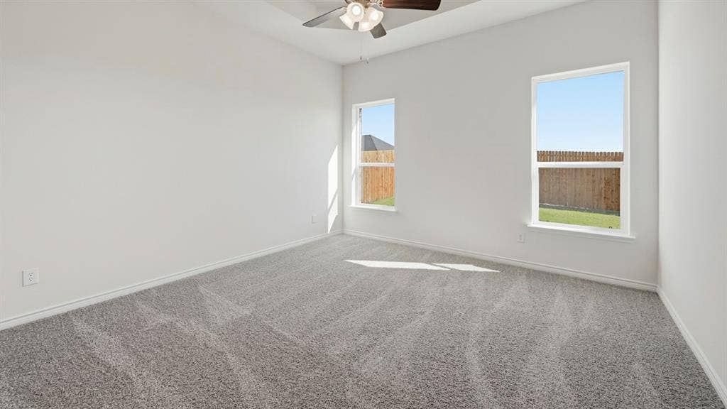 2506 Wesley Avenue, Royse City, TX 75189 Vaulted ceiling with a ceiling fan, two windows, wall-to-wall carpeting, and white baseboards