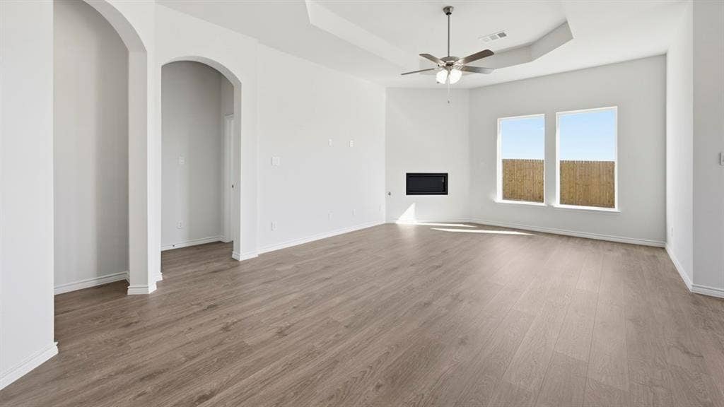 2506 Wesley Avenue, Royse City, TX 75189 Spacious interior featuring wood-finish flooring, a contemporary fireplace, and two large windows