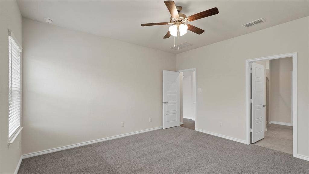 750 Hart Leaf Lane, Lavon, TX 75166 Spacious room featuring gray carpet flooring, light neutral-toned walls, and a ceiling fan with integrated lighting