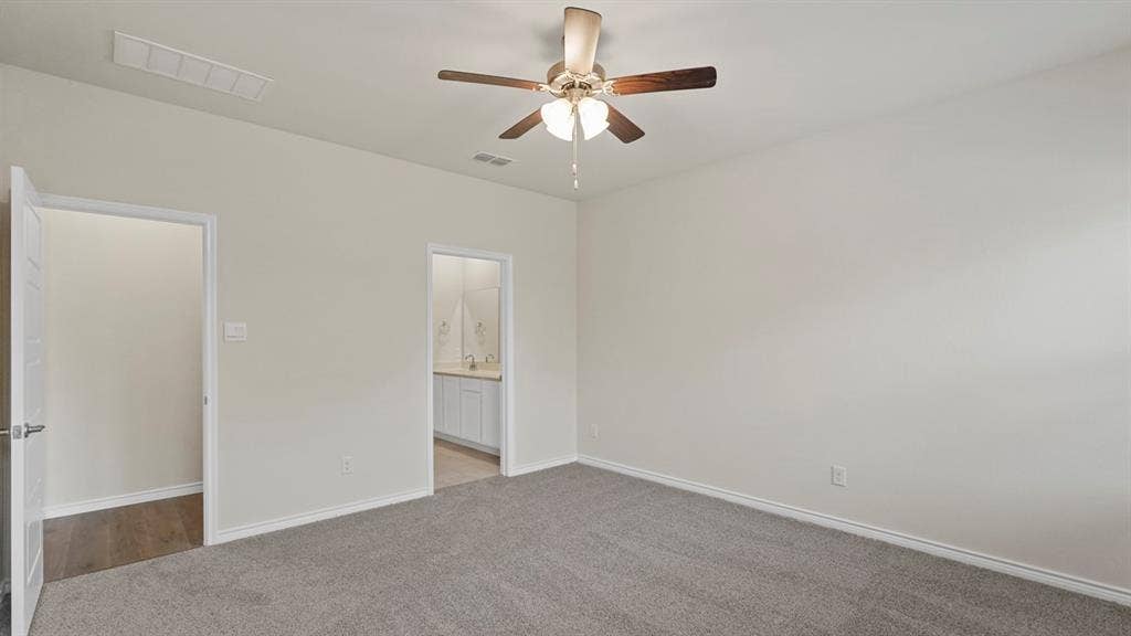 750 Hart Leaf Lane, Lavon, TX 75166 Spacious bedroom featuring neutral carpeting, light-colored walls, and a ceiling fan