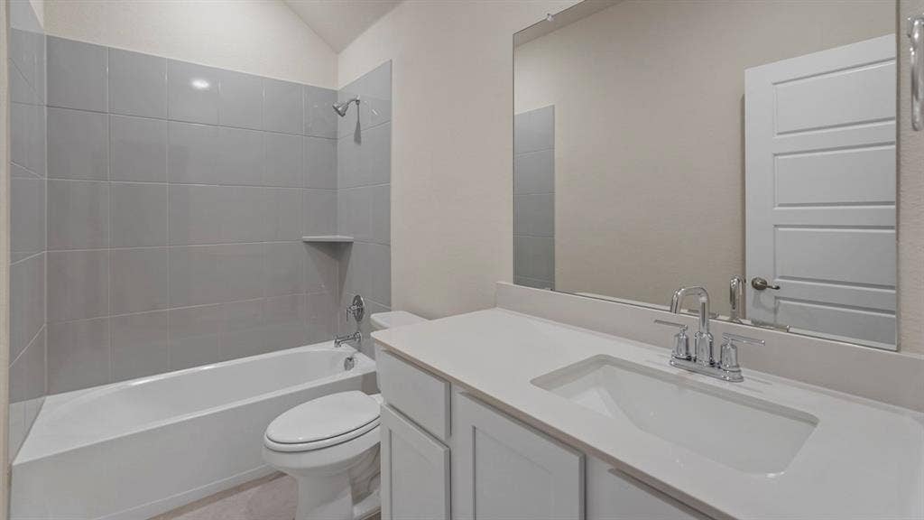 750 Hart Leaf Lane, Lavon, TX 75166 Bathroom featuring a white vanity with an integrated sink, polished chrome faucet, and expansive mirror