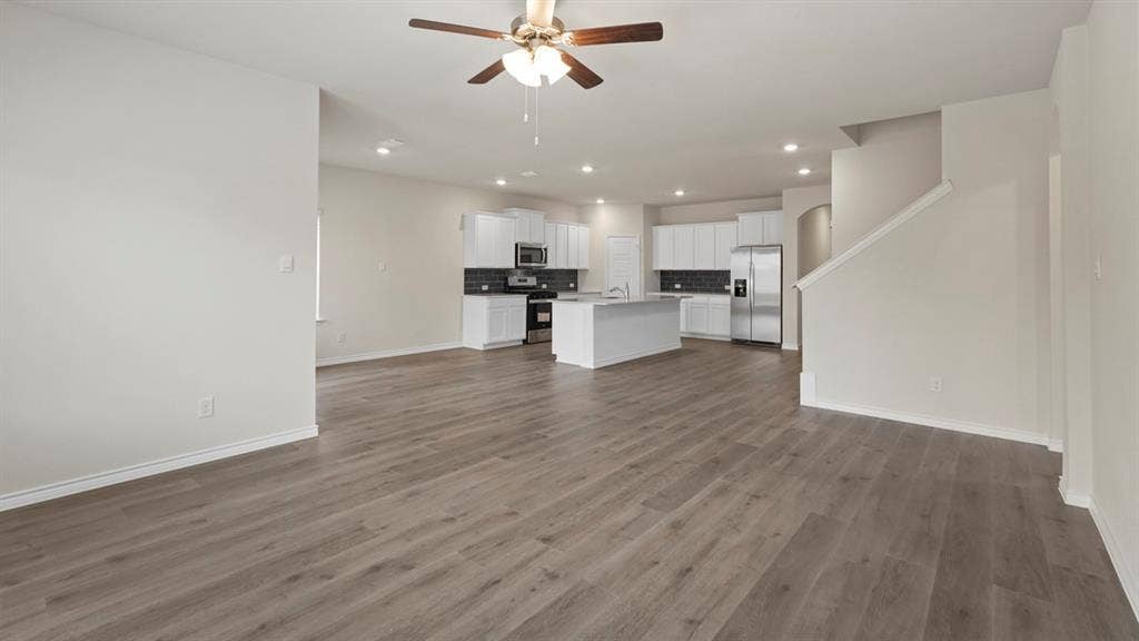 750 Hart Leaf Lane, Lavon, TX 75166 Open-concept living space featuring wood-finish flooring, recessed lighting, and a ceiling fan