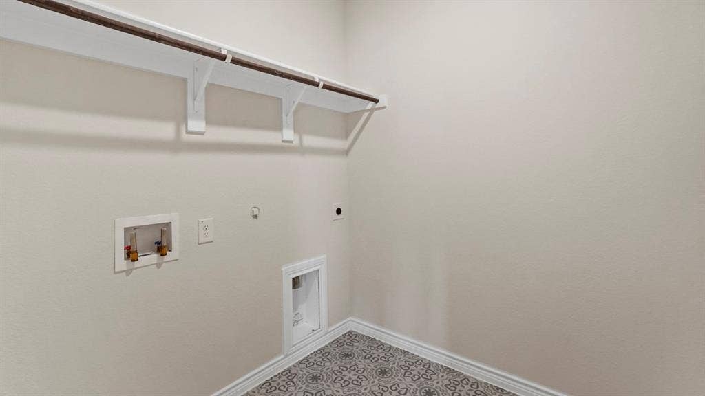 750 Hart Leaf Lane, Lavon, TX 75166 Laundry area featuring an overhead shelf with a clothing rod, patterned floor tiling, and neutral wall paint