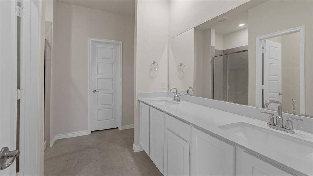 750 Hart Leaf Lane, Lavon, TX 75166 Double vanity with integrated sinks, white countertops, and chrome fixtures