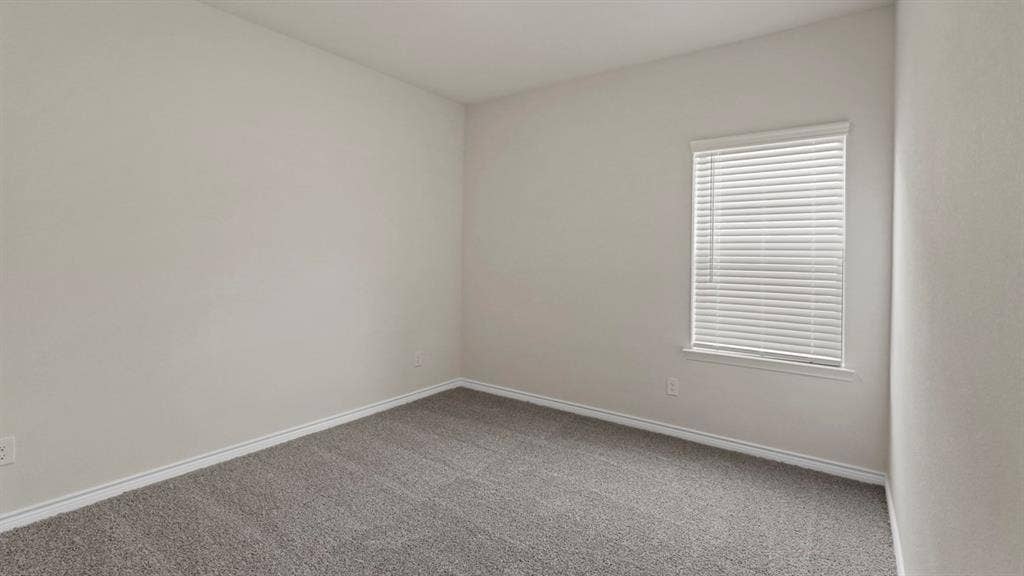750 Hart Leaf Lane, Lavon, TX 75166 Neutral-toned room featuring a single window with blinds, light gray walls, and gray carpeting