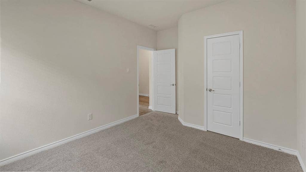 750 Hart Leaf Lane, Lavon, TX 75166 Neutral-toned walls and grey carpeting define this interior space