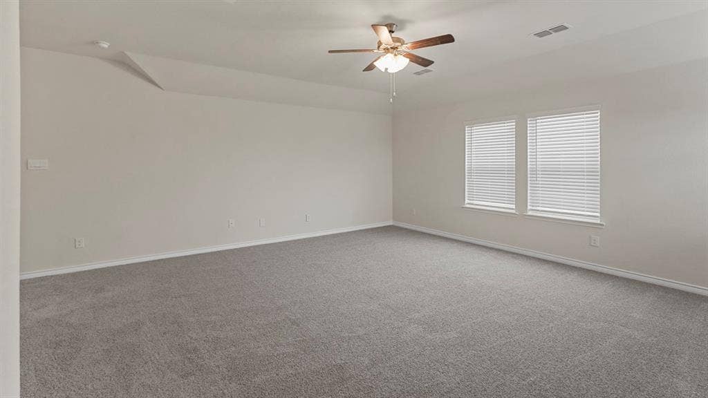750 Hart Leaf Lane, Lavon, TX 75166 Spacious room featuring neutral carpeting, light-toned walls, and a ceiling fan with integrated lighting