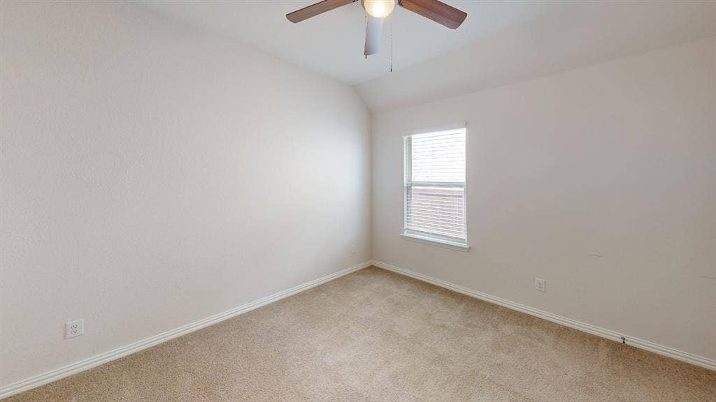 1004 Copper Smith Way, Forney, TX 75126 Carpeted room with a ceiling fan, a single window, and textured walls