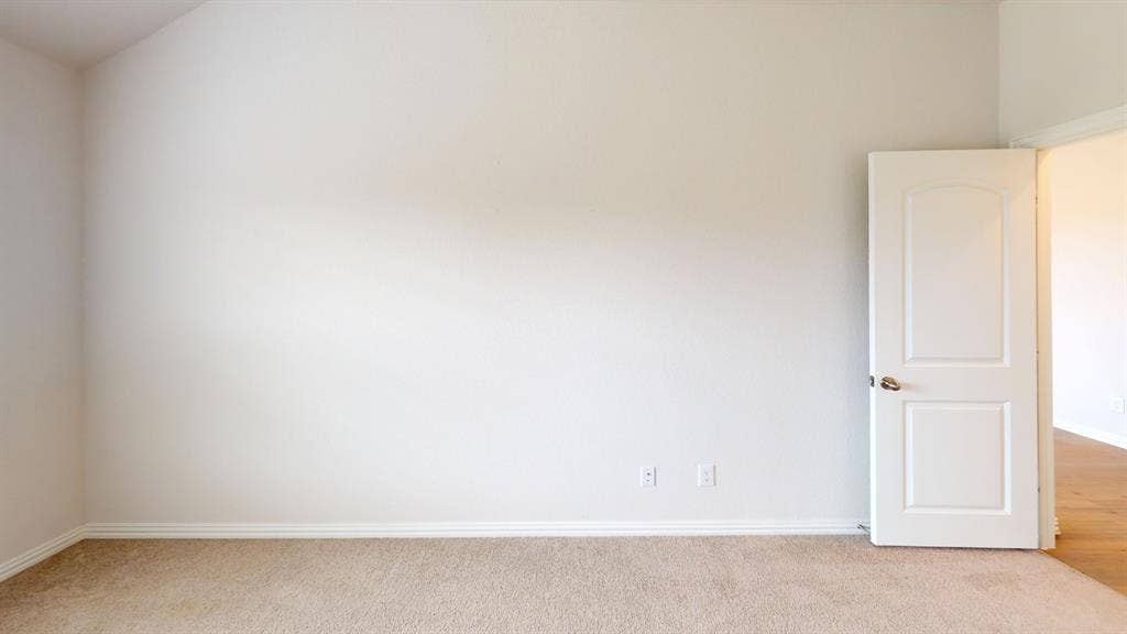 1004 Copper Smith Way, Forney, TX 75126 Textured wall finish, plush carpet flooring, white trim, and a white interior door