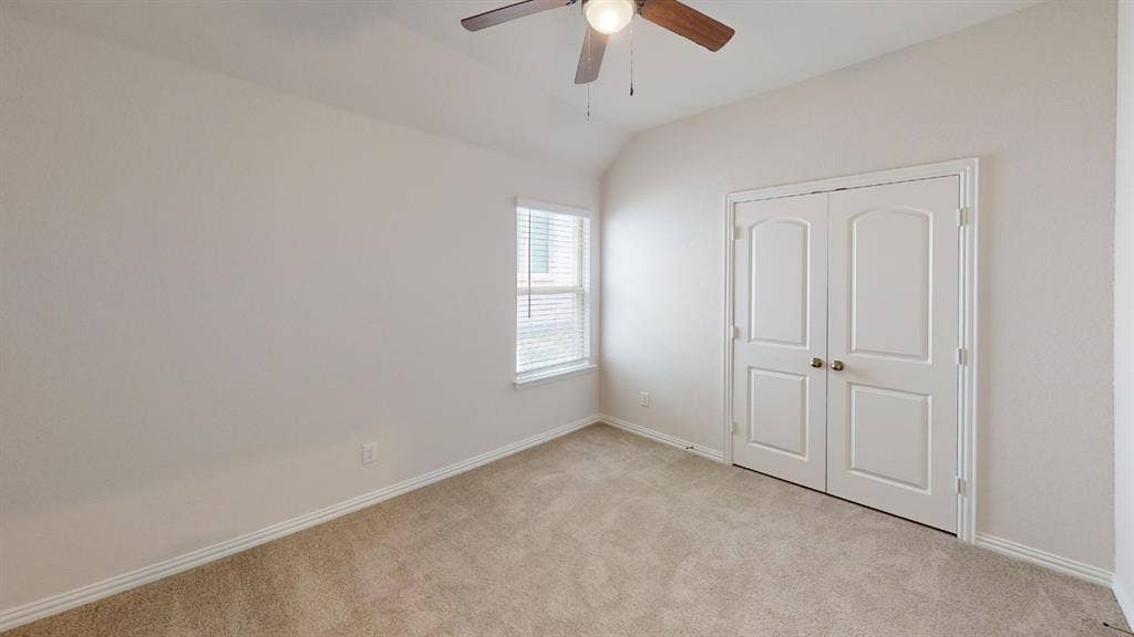 1004 Copper Smith Way, Forney, TX 75126 Vaulted ceiling with a wood-finish ceiling fan and attached light fixture