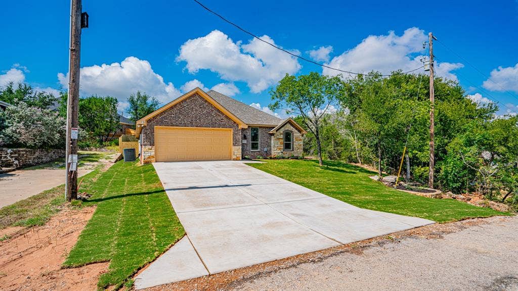 2714 Austin Drive, Granbury, TX 76048 Living area with wood look flooring and electric fireplace