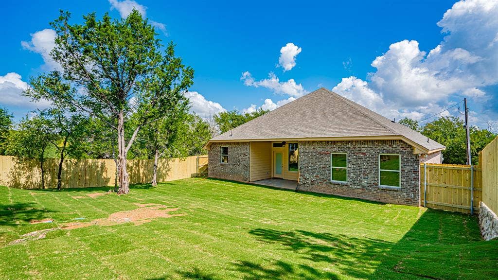2714 Austin Drive, Granbury, TX 76048 Covered patio at the back of home. Fenced and sodded yard.