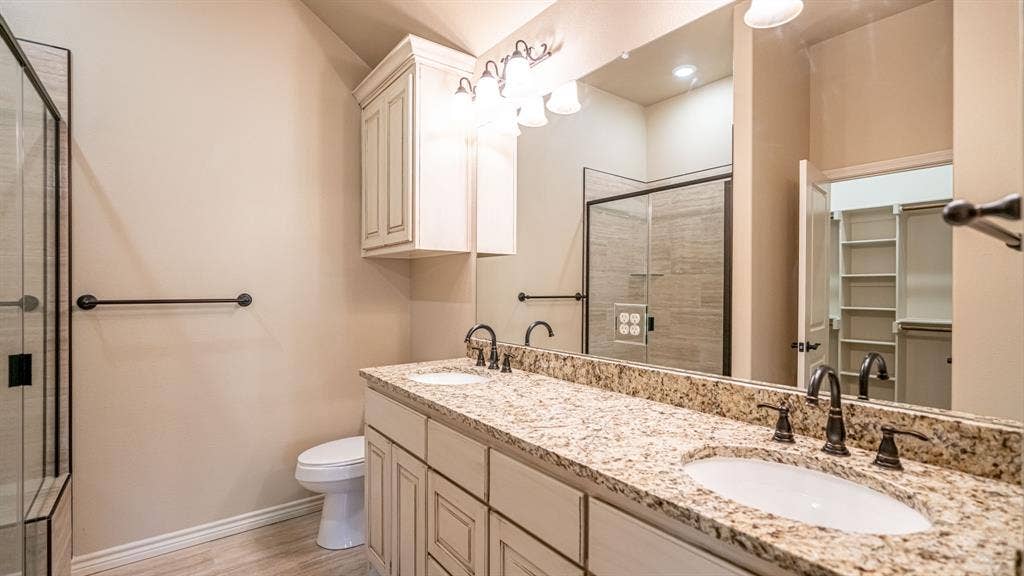 2714 Austin Drive, Granbury, TX 76048 Primary bathroom with dual sinks and walk in shower