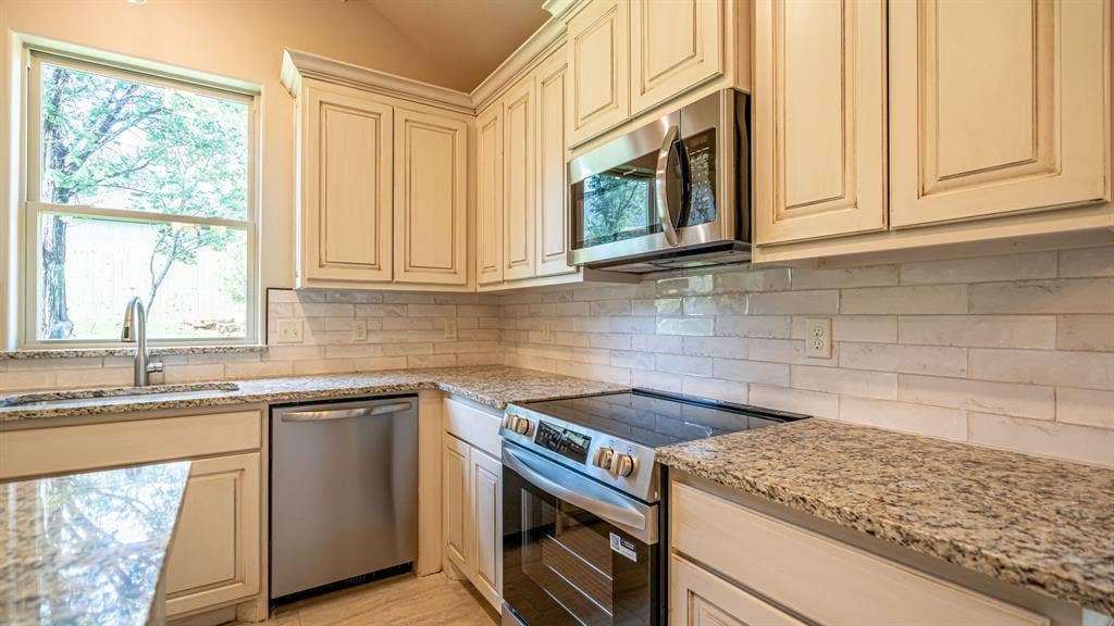 2714 Austin Drive, Granbury, TX 76048 Stainless appliances and granite countertops