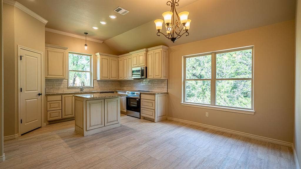 2714 Austin Drive, Granbury, TX 76048 Kitchen with beautiful custom cabinets and center island