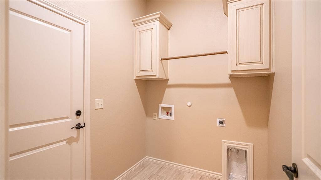 2714 Austin Drive, Granbury, TX 76048 Full sized laundry room with washer and dryer hook ups, cabinets and drying rod