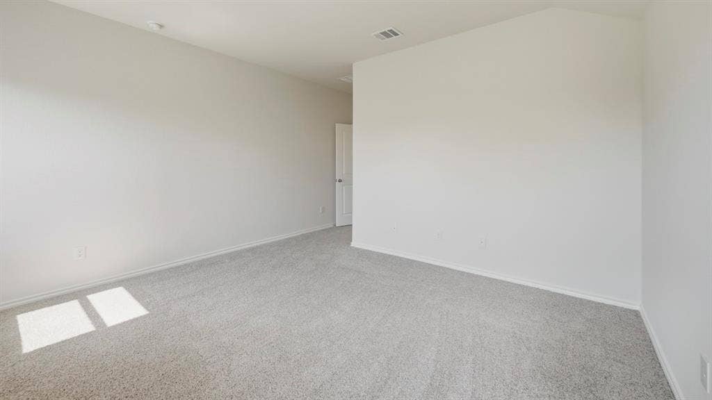 443 Epiphany Lane, Lavon, TX 75166 Spacious room featuring light gray carpeting, neutral wall finishes, white trim, and a white interior door