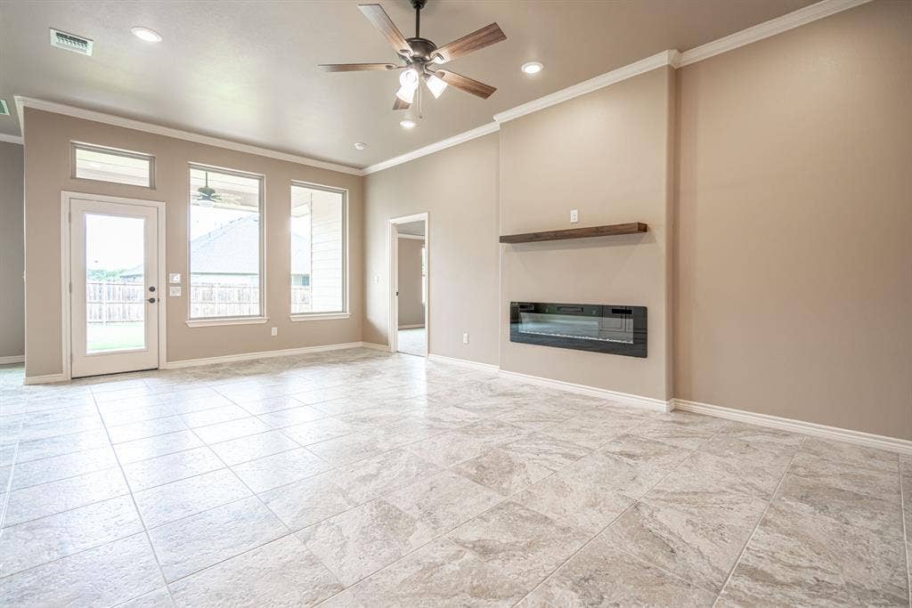 2600 Creek Drive, Granbury, TX 76048 Great room with wall of windows and electric fireplace