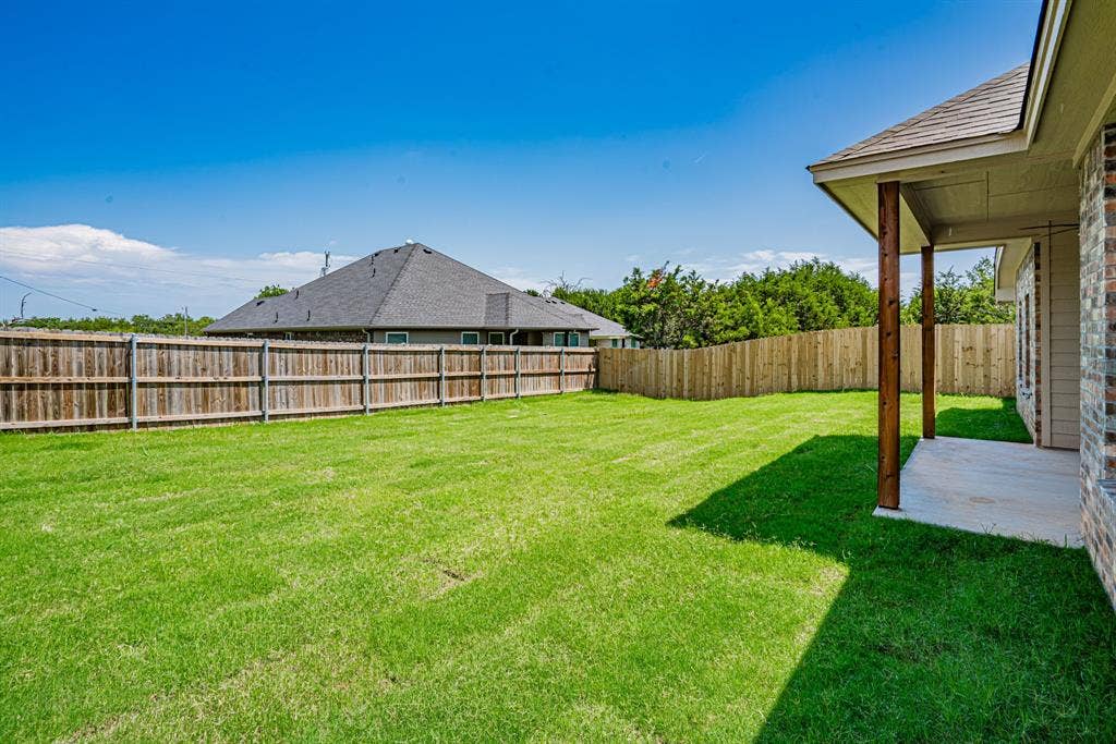 2600 Creek Drive, Granbury, TX 76048 Fully sodded back yard with privacy fence