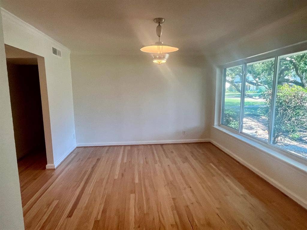 10409 Remington Lane, Dallas, TX 75229 Hardwood flooring, crown molding, white trim, recessed lighting, and a multi-pane window