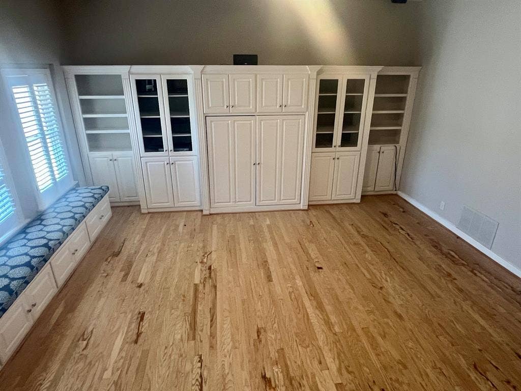 10409 Remington Lane, Dallas, TX 75229 Hardwood flooring throughout, custom built-in cabinetry with glass-front display, integrated storage, and window seating with storage