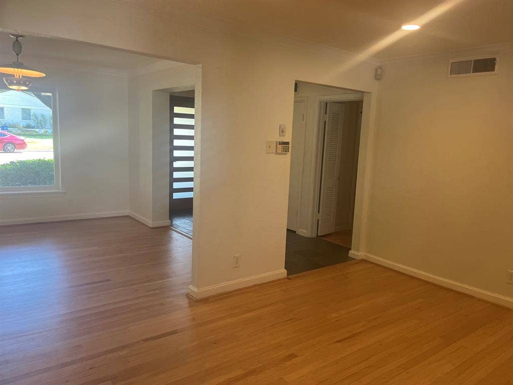 10409 Remington Lane, Dallas, TX 75229 Hardwood flooring, recessed lighting, and a modern entry door with frosted glass panels