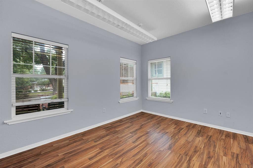 214 W Belt Line Road, #B, Cedar Hill, TX 75104 Wood-finish flooring with white trim, multiple windows with white blinds, and overhead lighting fixtures