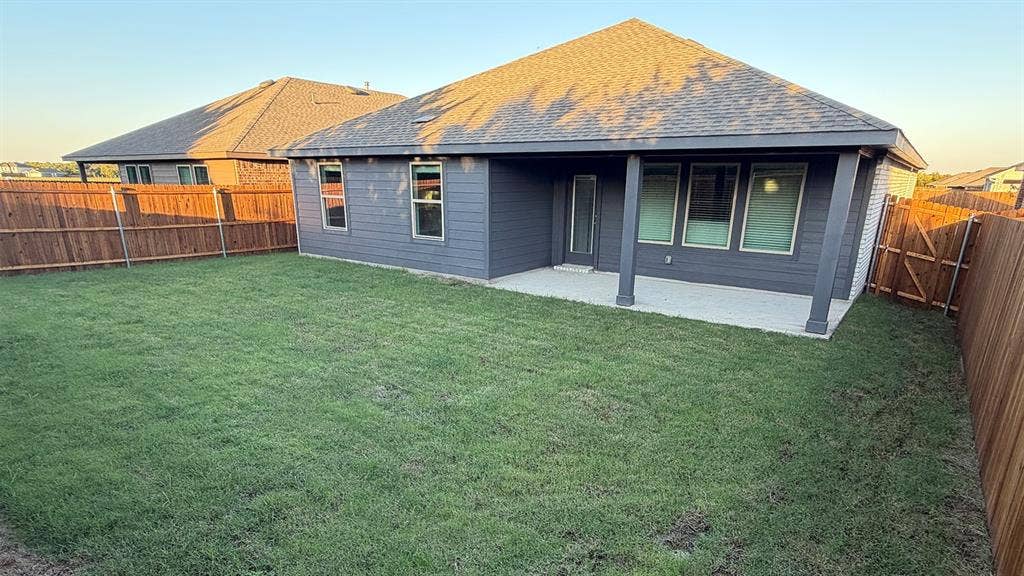 809 Brook Lane, Josephine, TX 75135 Expansive grassy yard area featuring a covered patio, privacy fencing, and exterior siding
