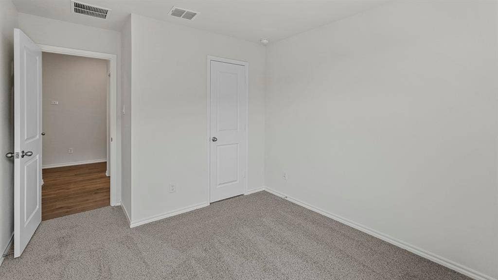 809 Brook Lane, Josephine, TX 75135 Neutral wall color, carpeted flooring, white trim, and white paneled doors