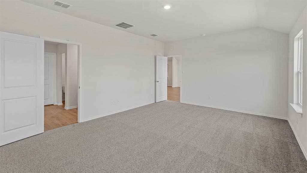 809 Brook Lane, Josephine, TX 75135 Vaulted ceiling, recessed lighting, double sliding panel doors, window, and grey carpet flooring