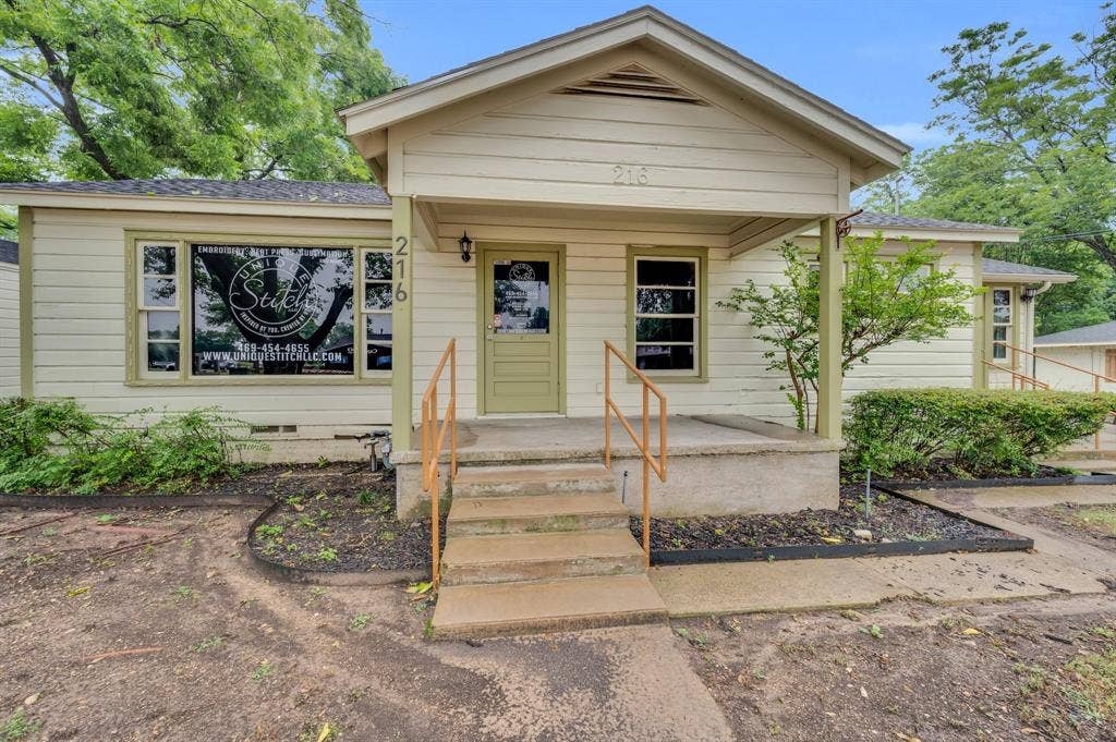 216 W Belt Line Road, Cedar Hill, TX 75104 Front facade featuring a covered porch with concrete steps and a handrail, multiple windows, and a prominent front door