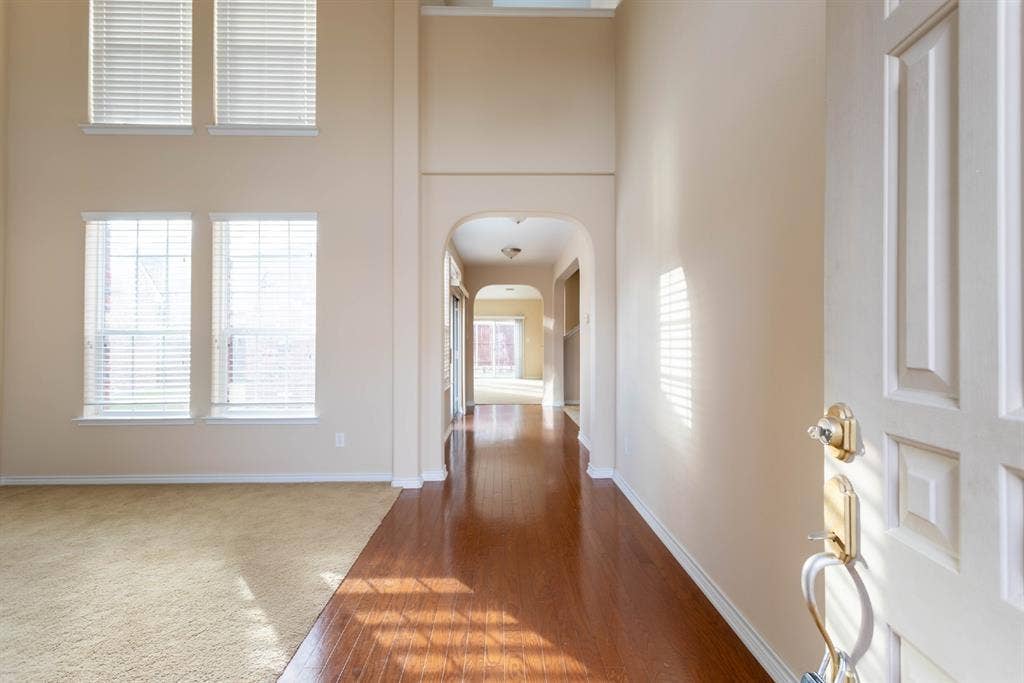 6509 Hickory Hill Drive, Plano, TX 75074 Two-story entryway with wood-finish flooring, arched doorway, and tall windows
