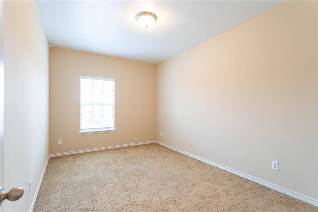 6509 Hickory Hill Drive, Plano, TX 75074 Carpeted room with a single window, overhead lighting, and neutral wall paint