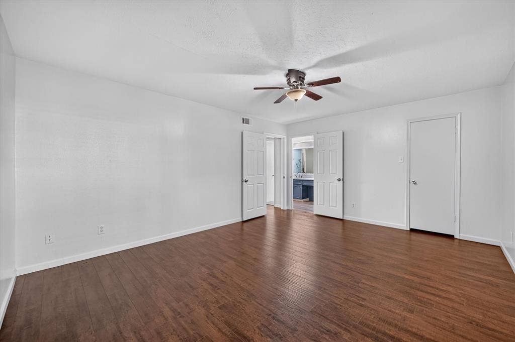 5043 Les Chateaux Drive, #214, Dallas, TX 75235 vinyl plank wood like finish flooring, white walls, and a ceiling fan with integrated lighting