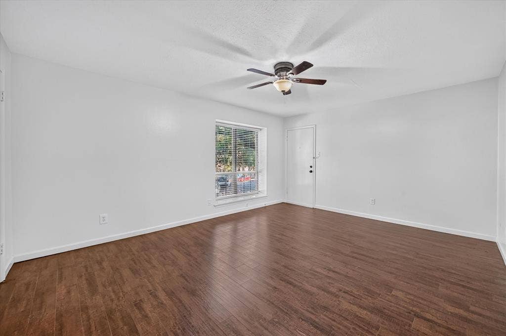 5043 Les Chateaux Drive, #214, Dallas, TX 75235 vinyl plank wood like finish flooring, white walls, and a ceiling fan with integrated lighting
