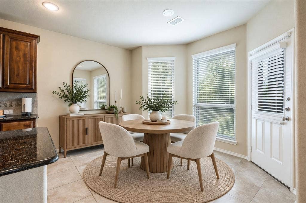 1300 Bellingham Circle, Glenn Heights, TX 75154 Virtually staged dining room with a clean, elegant design that highlights the space’s inviting atmosphere and natural flow.