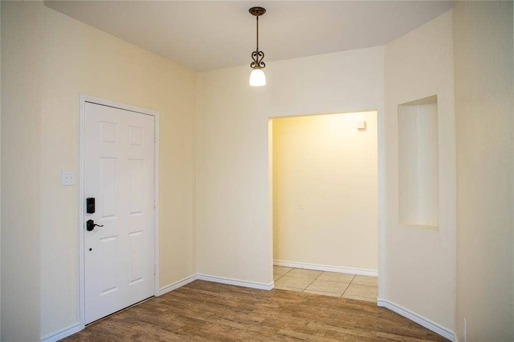 15534 Durango Drive, Frisco, TX 75035 Wood-finish flooring with light-toned walls, a decorative ceiling fixture, and a built-in wall niche