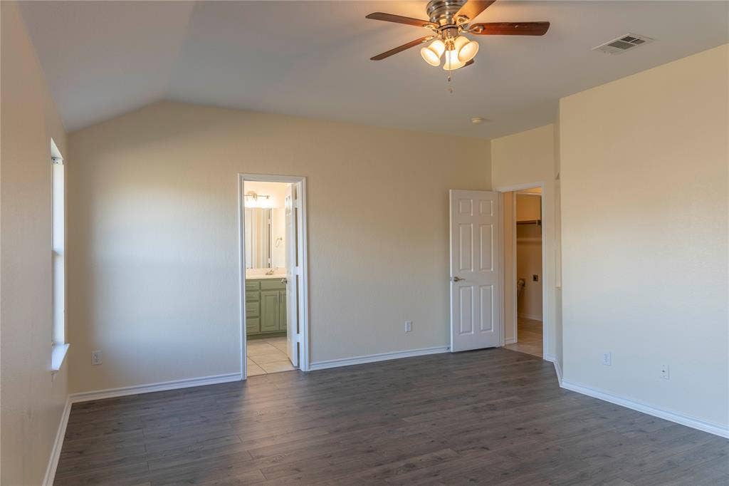 15534 Durango Drive, Frisco, TX 75035 Vaulted ceiling with a ceiling fan, wood-finish flooring, and white trim