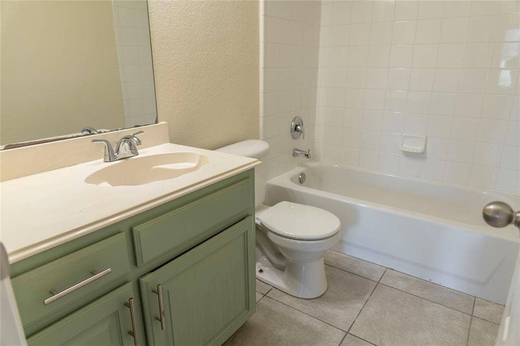 15534 Durango Drive, Frisco, TX 75035 Cream-toned vanity with an integrated sink, chrome faucet, and ample storage