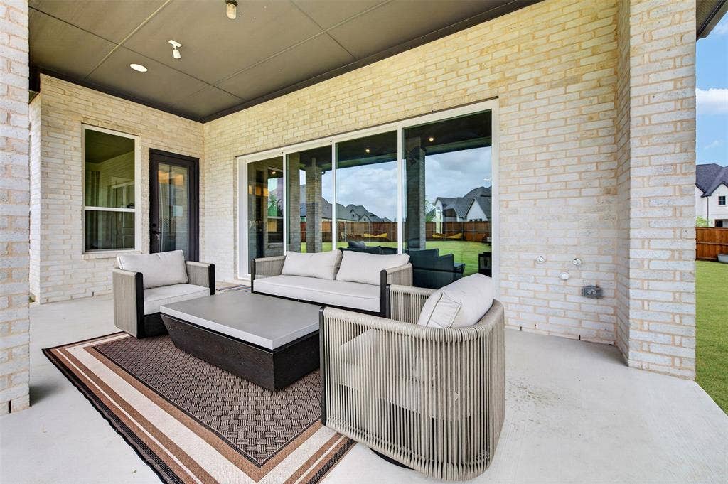 3312 Crosby Lane, Celina, TX 75009 Covered patio featuring a concrete slab and a light brick exterior