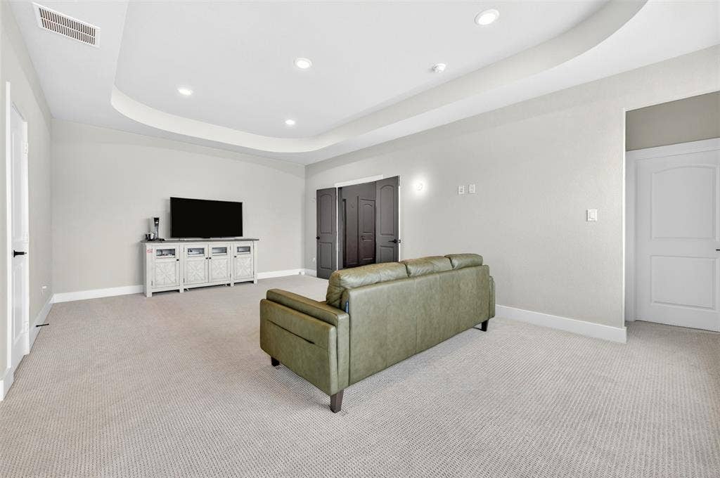 3312 Crosby Lane, Celina, TX 75009 Recessed lighting illuminates a tray ceiling and light-toned carpeting