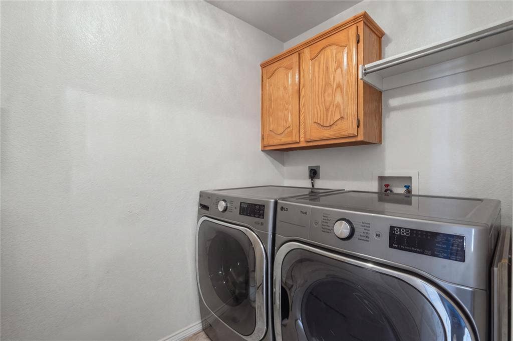 1125 Bayfield Drive, Denton, TX 76209 Laundry area with wood cabinetry and an integrated storage shelf