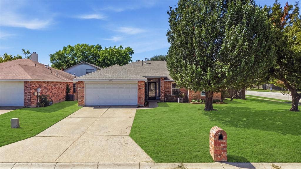 1125 Bayfield Drive, Denton, TX 76209 Brick exterior with an attached two-car garage
