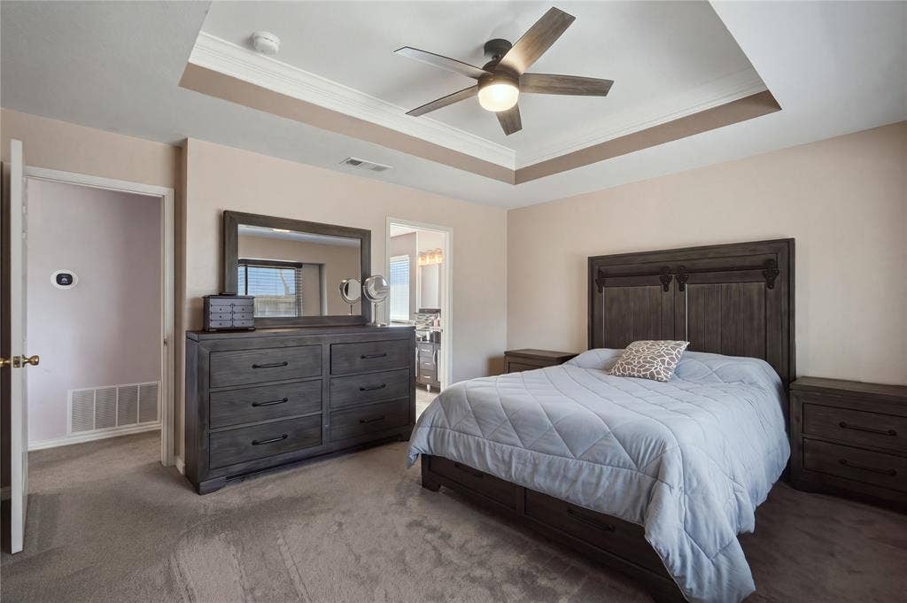 1125 Bayfield Drive, Denton, TX 76209 Tray ceiling with crown molding and a ceiling fan